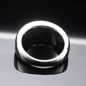 Minimalist black polished stainless steel ring with subtle textured groove marks
