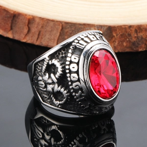 Macro detail of men's retro ring with red oval gemstone and antique silver embossed shank