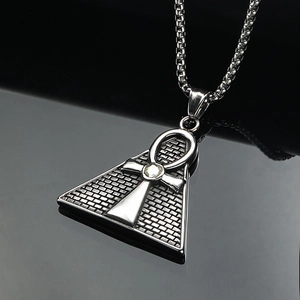 Pyramid necklace with Eye of Horus Ankh symbol and zircon stone on black mirror background