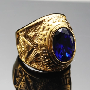 Detailed close-up of golden signet ring with blue gemstone and Eye of Providence symbol