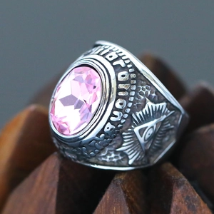 Macro shot of pink gemstone ring with vintage all-seeing eye engraving and silver finish