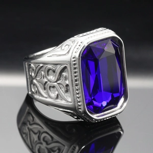 Detail of a large rectangular blue gemstone set in a vintage engraved silver steel ring