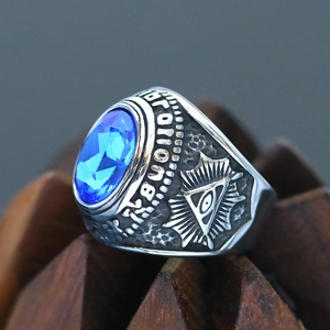 Macro shot of silver Masonic ring with blue gemstone and Orion All-Seeing Eye engraving