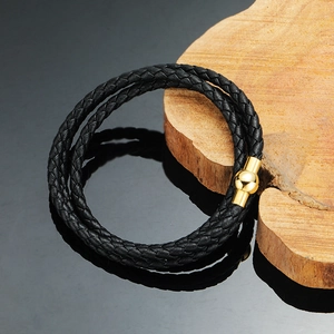 Double-wrap black braided leather bracelet featuring a polished gold magnetic ball clasp