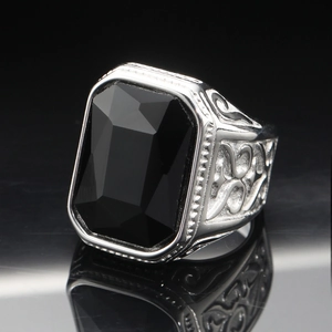 Macro shot of men's stainless steel ring featuring a large emerald-cut black gemstone