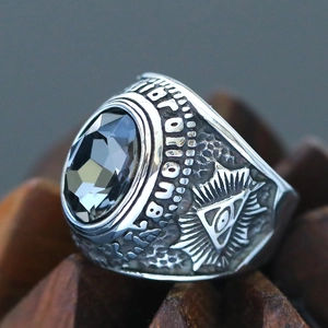 Macro shot of punk Freemason ring with black gemstone and Illuminati eye carvings