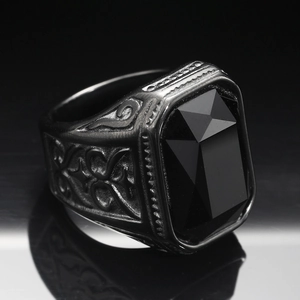 Macro detail of men's vintage black stainless steel ring with rectangular gemstone