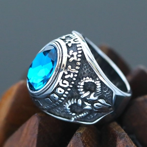 Detailed macro view of vintage men's signet ring with large blue oval stone and engravings