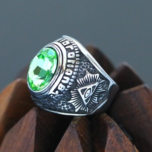 Macro shot of the Masonic All-Seeing Eye relief and green gemstone on vintage steel ring
