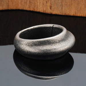 Minimalist oval titanium steel ring with retro textured finish and wave-like profile