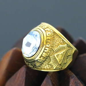 Macro detail of vintage gold Masonic ring with All-Seeing Eye and white gemstone