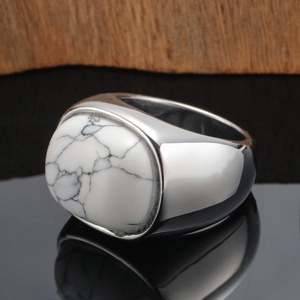 Mens silver signet ring with large oval white turquoise stone on black mirror surface