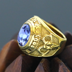 Macro view of vintage gold punk ring with large faceted purple gemstone and relief details