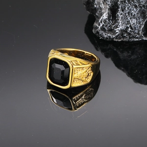 Detailed close-up of a golden Freemasonry ring featuring a square black gemstone