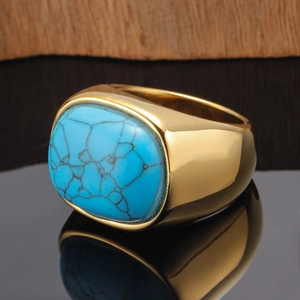 Detailed view of vintage gold ring featuring a large rectangular turquoise stone with web texture