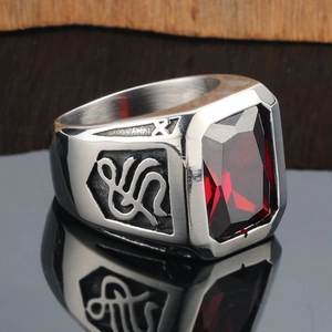 Vintage stainless steel ring for men featuring a large rectangular red gemstone and carvings