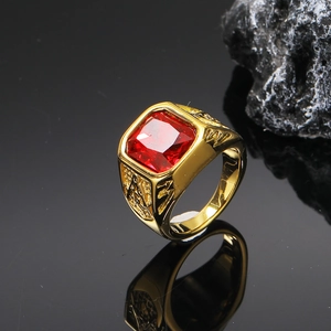 Macro shot of gold-plated Freemason signet ring with a large square-cut red ruby stone