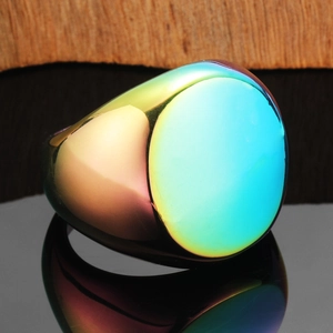 Polished rainbow stainless steel signet ring with flat oval surface on black mirror