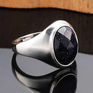 Mens silver titanium steel ring featuring oval blue goldstone inlay with star effect