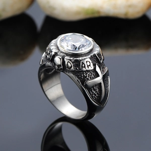 Retro punk skull ring in aged steel with cross details and a large clear zircon stone