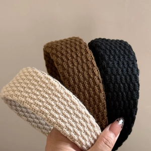 Three minimalist knitted wide headbands in cream, coffee, and black for women’s hair styling
