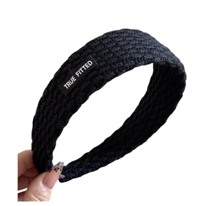 Solid black knitted headband for women with white True Fitted label patch design