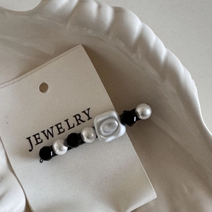 French vintage hair clip with pearls and acrylic beads on jewelry display card