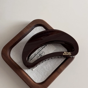 Detail view of large chocolate brown shark hair claw clip with golden Barrette LaFrance logo