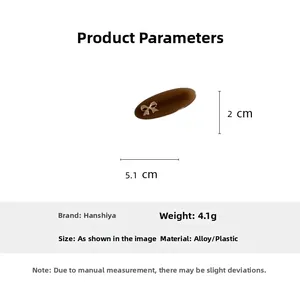 Detail view of brown oval acetate hair clip with gold metal bow and size specifications
