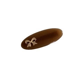Vintage brown oval hair clip with gold bow accent for elegant women's hairstyles