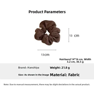 Detailed view of brown plush fabric scrunchie with 13cm diameter and 21.8g weight specs