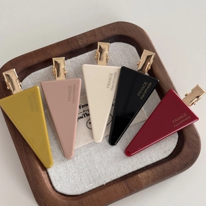 Five-piece triangular hair clip set in vintage colors like yellow, pink, and burgundy