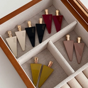 Detailed view of colorful triangular resin hair clips with France Handmade gold text