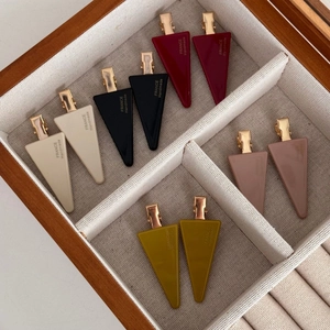 Detail of colorful matte resin hair clips in a wooden box with France Handmade engraving