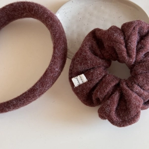 Detailed view of plush burgundy scrunchie and headband with warm fuzzy fabric texture