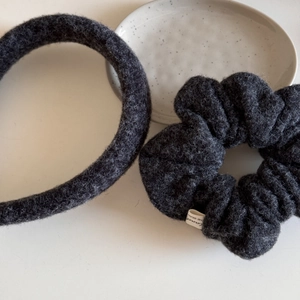 Detail of dark grey wool blend scrunchie and headband set on a ceramic tray
