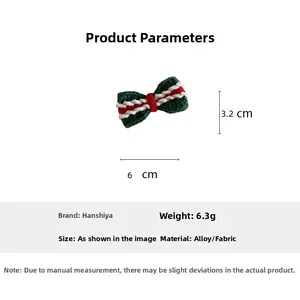 Detailed view of handmade knitted Christmas bow hair clip with size and weight specs