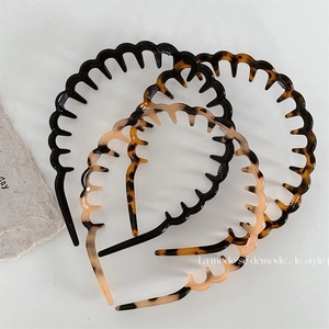 Three-piece acetate wavy toothed hairbands in black, tortoiseshell and amber patterns