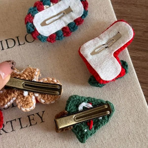 Detailed back view of handmade crochet Christmas hair clips with metal duckbill fasteners