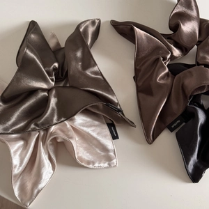 Detail of silk satin scrunchies in bronze and champagne with handmade label