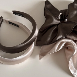 Detail of champagne and coffee silk satin headbands and bow scrunchies with handmade labels