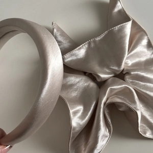 Detail of beige mercerized satin headband and oversized scrunchie set with silk luster