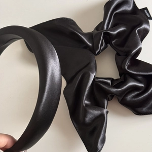 Detail of black silk satin hair scrunchie with handmade label and matching headband set