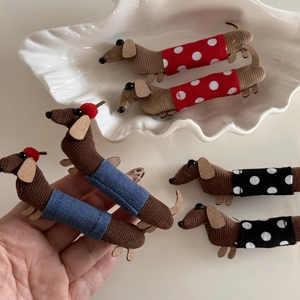 Detail of cute dachshund dog hair clips in brown corduroy fabric with polka dot outfits
