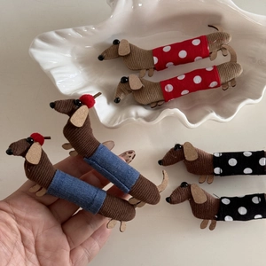 Detail of handmade corduroy dachshund hair clips with various polka dot fabric patterns