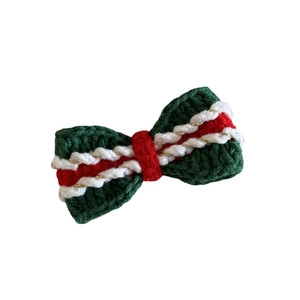Handmade crochet Christmas bow hair clip in green and red yarn with gold tinsel