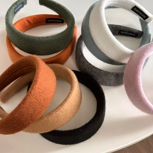 Set of eight assorted handmade wide fabric headbands in autumn colors on white background
