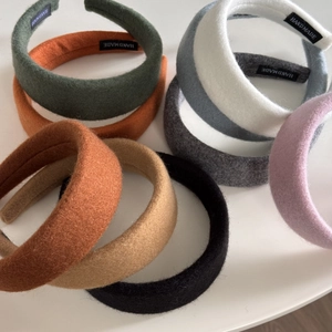 Macro shot of assorted colorful handmade padded headbands with wool texture detailing