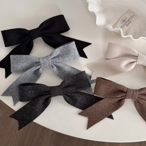 Elegant Morandi color knit ribbon bow hair clips in five colors on a minimalist background