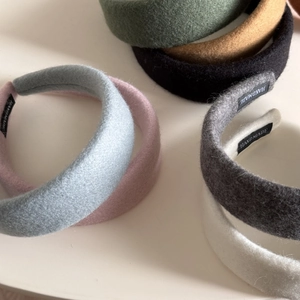 Detail of handmade thick fabric headbands showing soft texture and inner black label